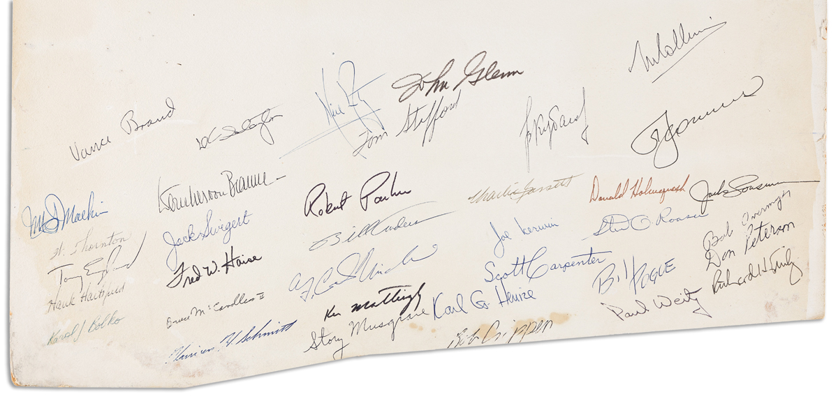 (ASTRONAUTS.) Signatures by over 30 astronauts, cosmonauts, and support crew, on a large board.